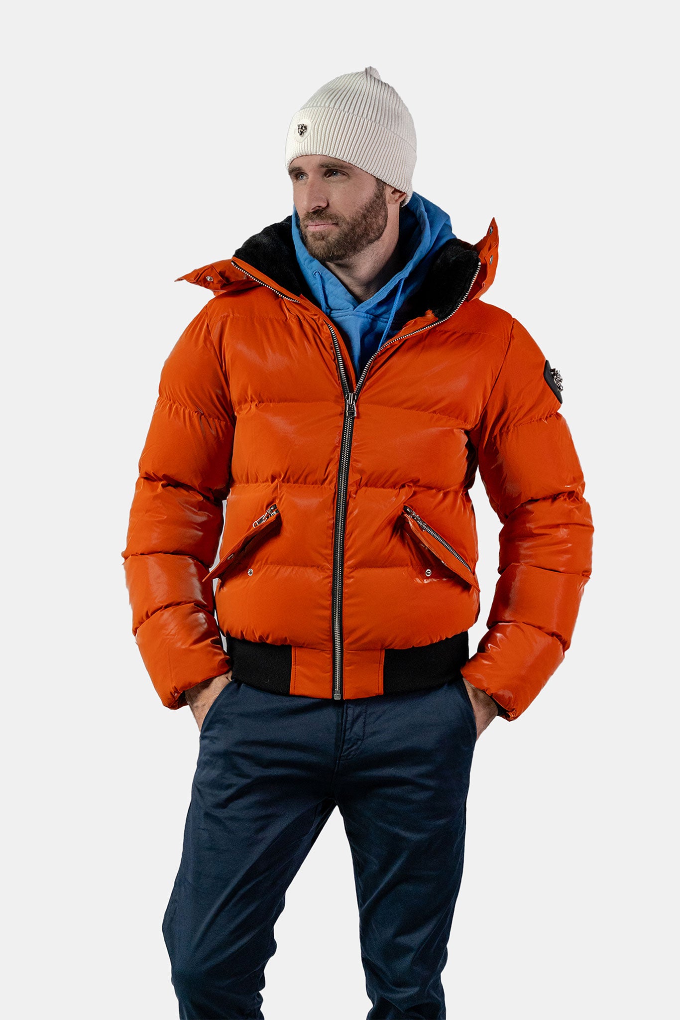 Woodpecker Men's Woody Bomber Winter coat. High-end Canadian designer winter coat for men in "All Wet Orange" colour. Woodpecker cruelty-free winter coat designed in Canada. Men's heavy weight short length premium designer jacket for winter. Superior quality warm winter coat for men. Moose Knuckles, Canada Goose, Mackage, Montcler, Will Poho, Willbird, Nic Bayley. Shiny parka. Stylish winter jacket. Designer winter coat.