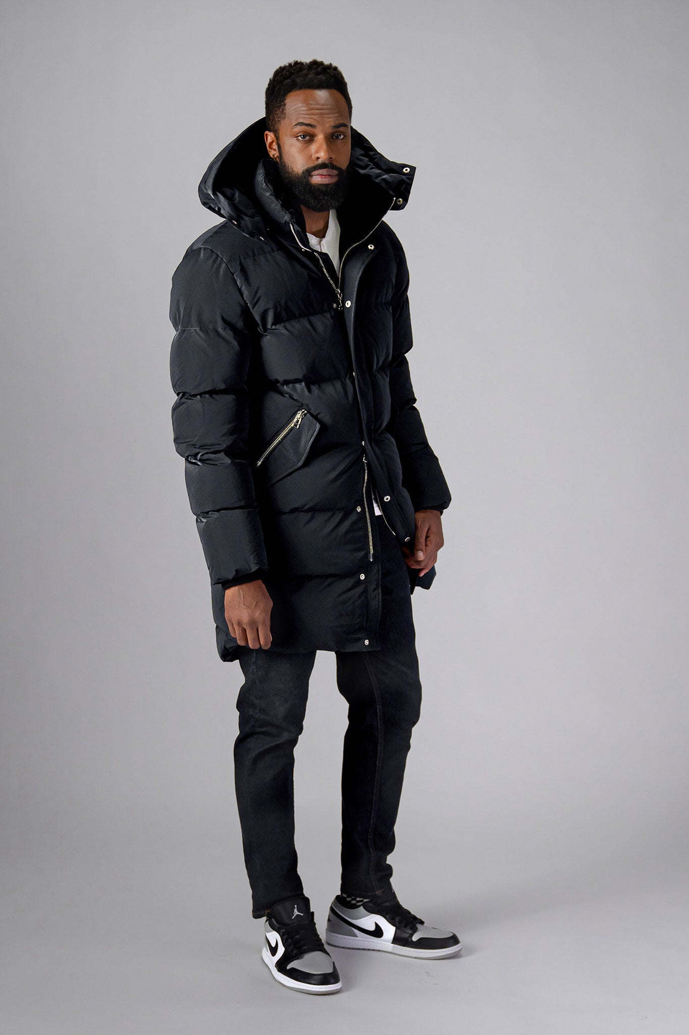 Woodpecker Men's Penguin Long Winter coat. High-end Canadian designer winter coat for men in "Black Diamond" colour. Woodpecker cruelty-free winter coat designed in Canada. Men's heavy weight long length premium designer jacket for winter. Superior quality warm winter coat for men. Moose Knuckles, Canada Goose, Mackage, Montcler, Will Poho, Willbird, Nic Bayley. Extra warm. Shiny parka. Stylish winter jacket. Designer winter coat.