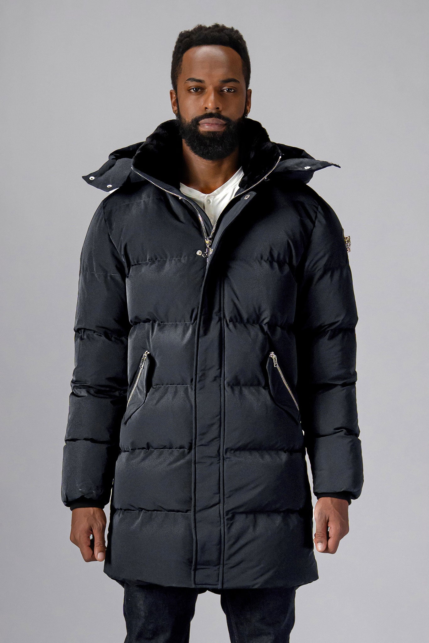 Woodpecker Men's Penguin Long Winter coat. High-end Canadian designer winter coat for men in "Black Diamond" colour. Woodpecker cruelty-free winter coat designed in Canada. Men's heavy weight long length premium designer jacket for winter. Superior quality warm winter coat for men. Moose Knuckles, Canada Goose, Mackage, Montcler, Will Poho, Willbird, Nic Bayley. Extra warm. Shiny parka. Stylish winter jacket. Designer winter coat.