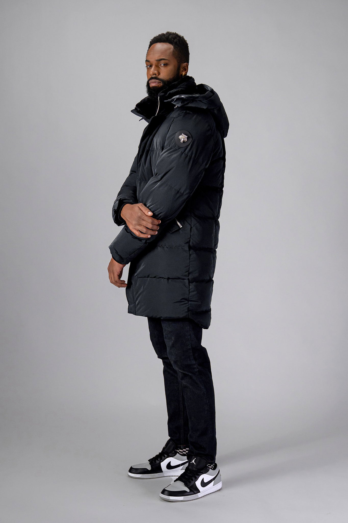 Woodpecker Men's Penguin Long Winter coat. High-end Canadian designer winter coat for men in "Black Diamond" colour. Woodpecker cruelty-free winter coat designed in Canada. Men's heavy weight long length premium designer jacket for winter. Superior quality warm winter coat for men. Moose Knuckles, Canada Goose, Mackage, Montcler, Will Poho, Willbird, Nic Bayley. Extra warm. Shiny parka. Stylish winter jacket. Designer winter coat.