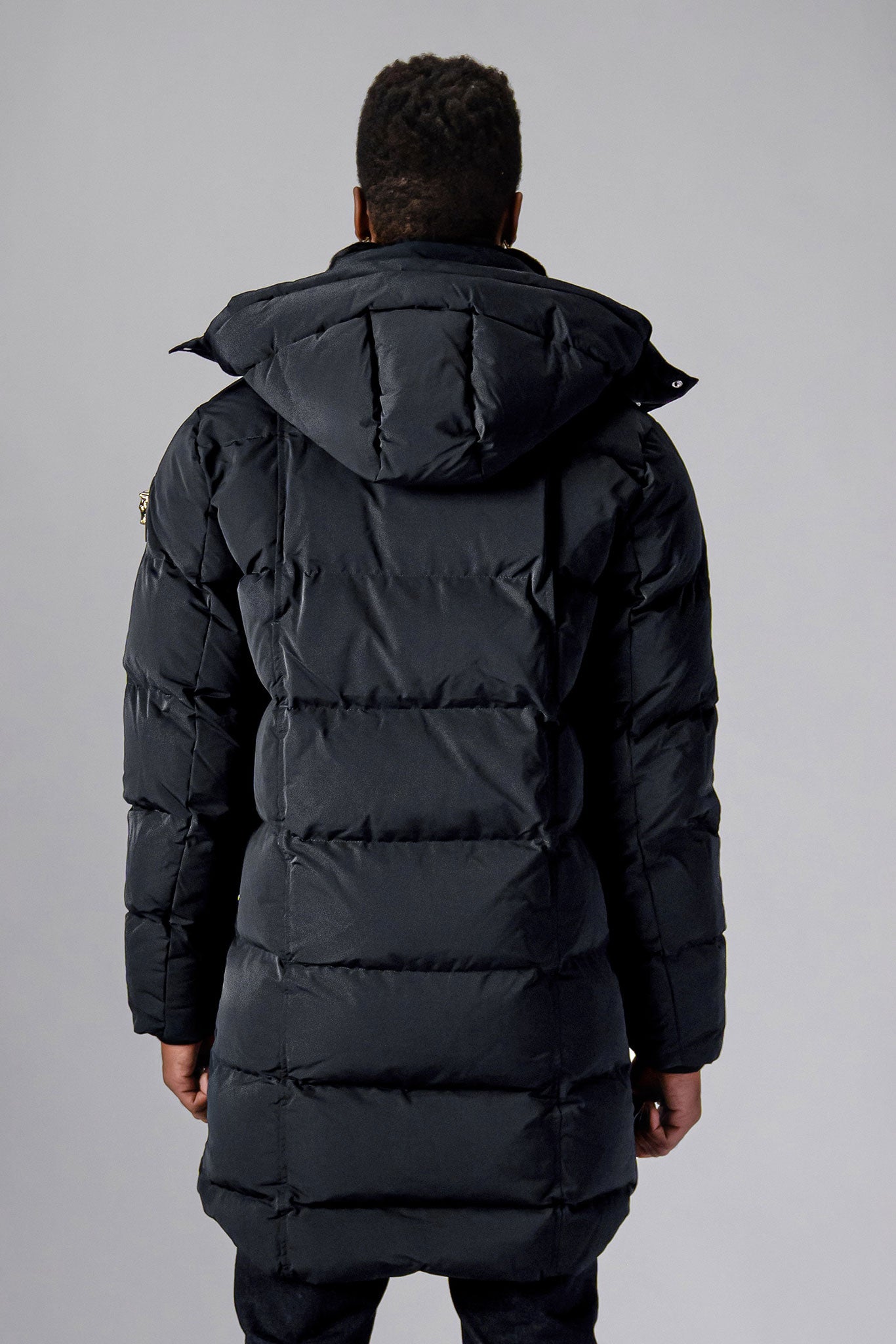 Woodpecker Men's Penguin Long Winter coat. High-end Canadian designer winter coat for men in "Black Diamond" colour. Woodpecker cruelty-free winter coat designed in Canada. Men's heavy weight long length premium designer jacket for winter. Superior quality warm winter coat for men. Moose Knuckles, Canada Goose, Mackage, Montcler, Will Poho, Willbird, Nic Bayley. Extra warm. Shiny parka. Stylish winter jacket. Designer winter coat.