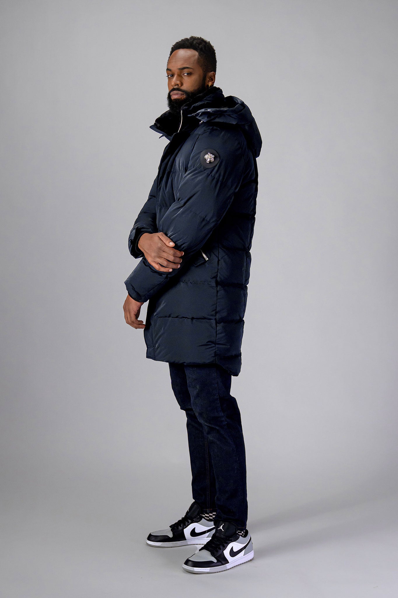 Woodpecker Men's Penguin Long Winter coat. High-end Canadian designer winter coat for men in "Blue Diamond" colour. Woodpecker cruelty-free winter coat designed in Canada. Men's heavy weight long length premium designer jacket for winter. Superior quality warm winter coat for men. Moose Knuckles, Canada Goose, Mackage, Montcler, Will Poho, Willbird, Nic Bayley. Extra warm. Shiny parka. Stylish winter jacket. Designer winter coat.