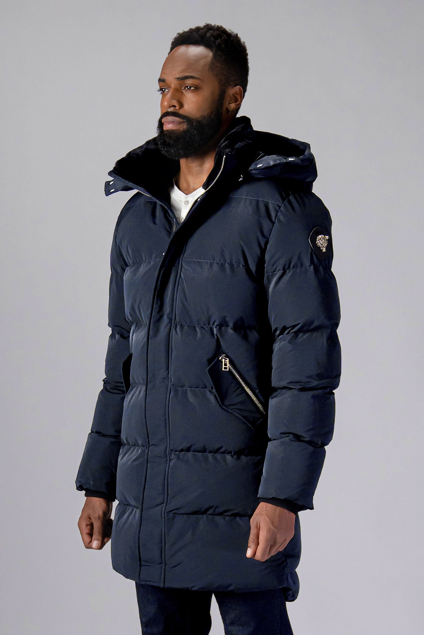 Woodpecker Men's Penguin Long Winter coat. High-end Canadian designer winter coat for men in "Blue Diamond" colour. Woodpecker cruelty-free winter coat designed in Canada. Men's heavy weight long length premium designer jacket for winter. Superior quality warm winter coat for men. Moose Knuckles, Canada Goose, Mackage, Montcler, Will Poho, Willbird, Nic Bayley. Extra warm. Shiny parka. Stylish winter jacket. Designer winter coat.