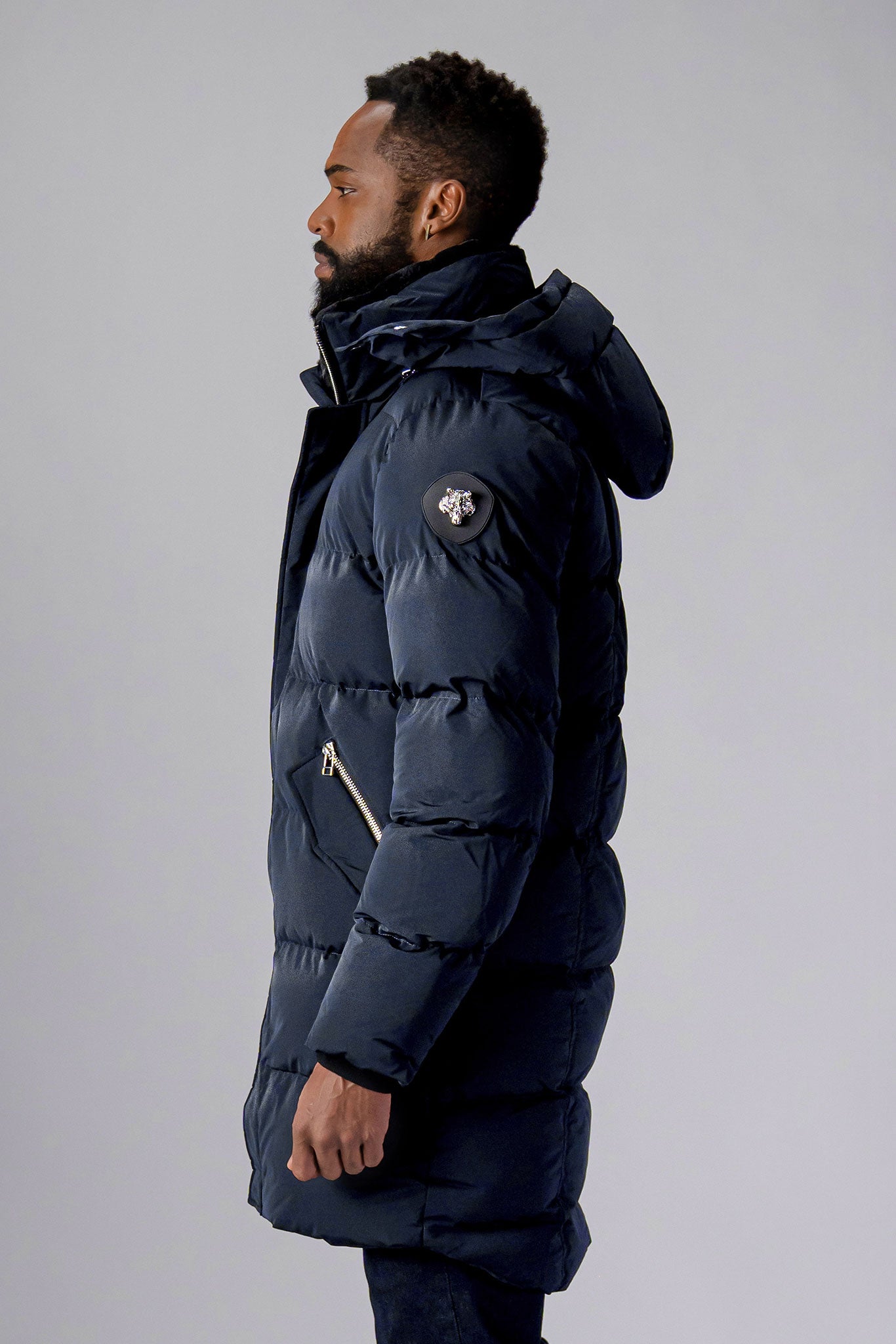 Woodpecker Men's Penguin Long Winter coat. High-end Canadian designer winter coat for men in "Blue Diamond" colour. Woodpecker cruelty-free winter coat designed in Canada. Men's heavy weight long length premium designer jacket for winter. Superior quality warm winter coat for men. Moose Knuckles, Canada Goose, Mackage, Montcler, Will Poho, Willbird, Nic Bayley. Extra warm. Shiny parka. Stylish winter jacket. Designer winter coat.
