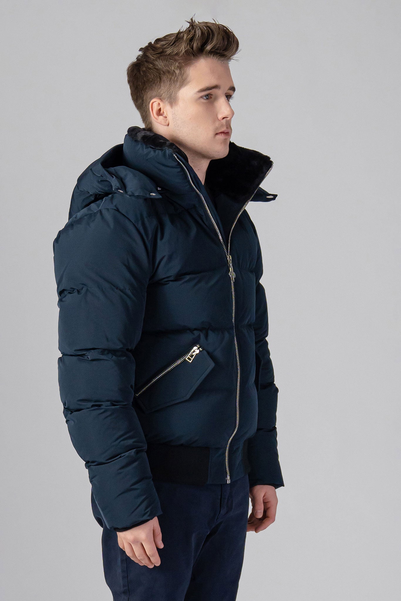 Woodpecker Men's Woody Bomber Winter coat. High-end Canadian designer winter coat for men in “Matte Navy" colour. Woodpecker cruelty-free winter coat designed in Canada. Men's heavy weight short length premium designer jacket for winter. Superior quality warm winter coat for men. Moose Knuckles, Canada Goose, Mackage, Montcler, Will Poho, Willbird, Nic Bayley. Shiny parka. Stylish winter jacket. Designer winter coat.