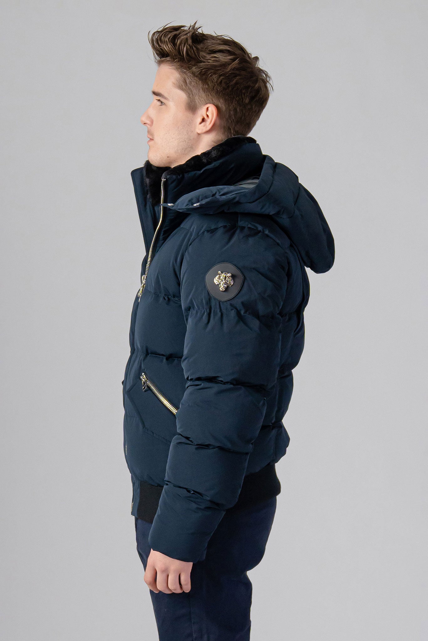 Woodpecker Men's Woody Bomber Winter coat. High-end Canadian designer winter coat for men in “Matte Navy" colour. Woodpecker cruelty-free winter coat designed in Canada. Men's heavy weight short length premium designer jacket for winter. Superior quality warm winter coat for men. Moose Knuckles, Canada Goose, Mackage, Montcler, Will Poho, Willbird, Nic Bayley. Shiny parka. Stylish winter jacket. Designer winter coat.