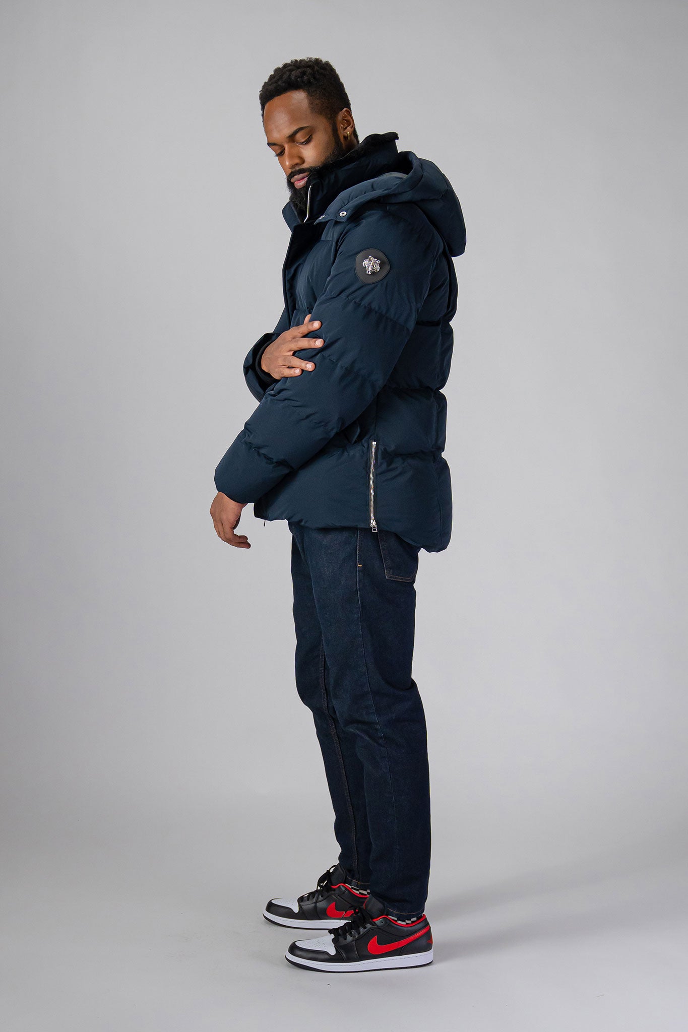 High-end Canadian designer winter coat for men in "Matte Navy" colour. Woodpecker cruelty-free winter coat designed in Canada. Men's heavy weight medium length premium designer jacket for winter. Superior quality warm winter coat for men. Moose Knuckles, Canada Goose, Mackage, Montcler, Will Poho, Willbird, Nic Bayley. Shiny parka. Stylish winter jacket. Designer winter coat.