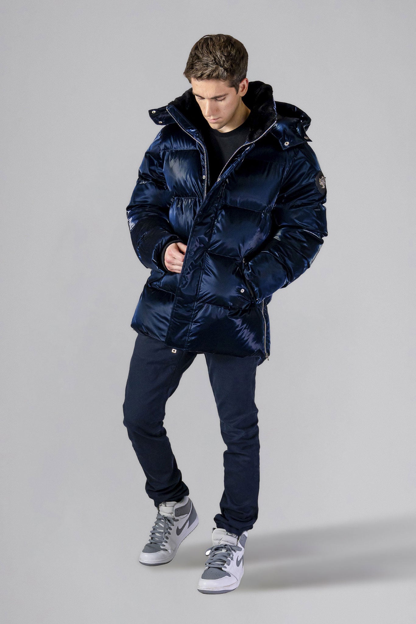 Woodpecker Men's Bumnester Winter coat. High-end Canadian designer winter coat for men in "All Wet Navy" colour. Woodpecker cruelty-free winter coat designed in Canada. Men's heavy weight medium length premium designer jacket for winter. Superior quality warm winter coat for men. Moose Knuckles, Canada Goose, Mackage, Montcler, Will Poho, Willbird, Nic Bayley. Shiny parka. Stylish winter jacket. Designer winter coat.
