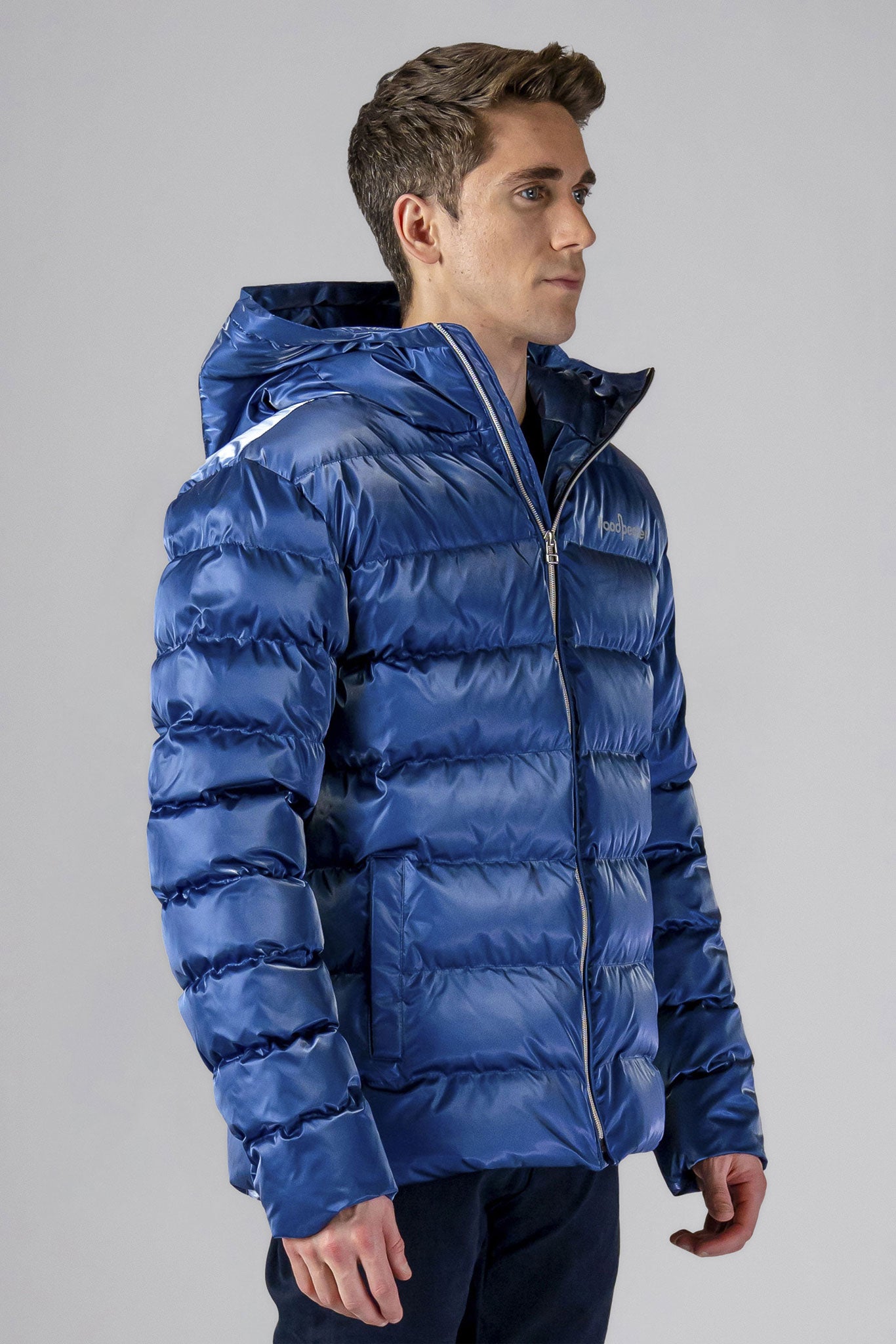 High-end Canadian designer winter coat for men in "Flash Blue" colour. Woodpecker cruelty-free winter coat designed in Canada. Men's medium weight medium length premium designer jacket for winter. Superior quality warm winter coat for men. Moose Knuckles, Canada Goose, Mackage, Montcler, Will Poho, Willbird, Nic Bayley. Shiny parka. Stylish winter jacket. Designer winter coat.