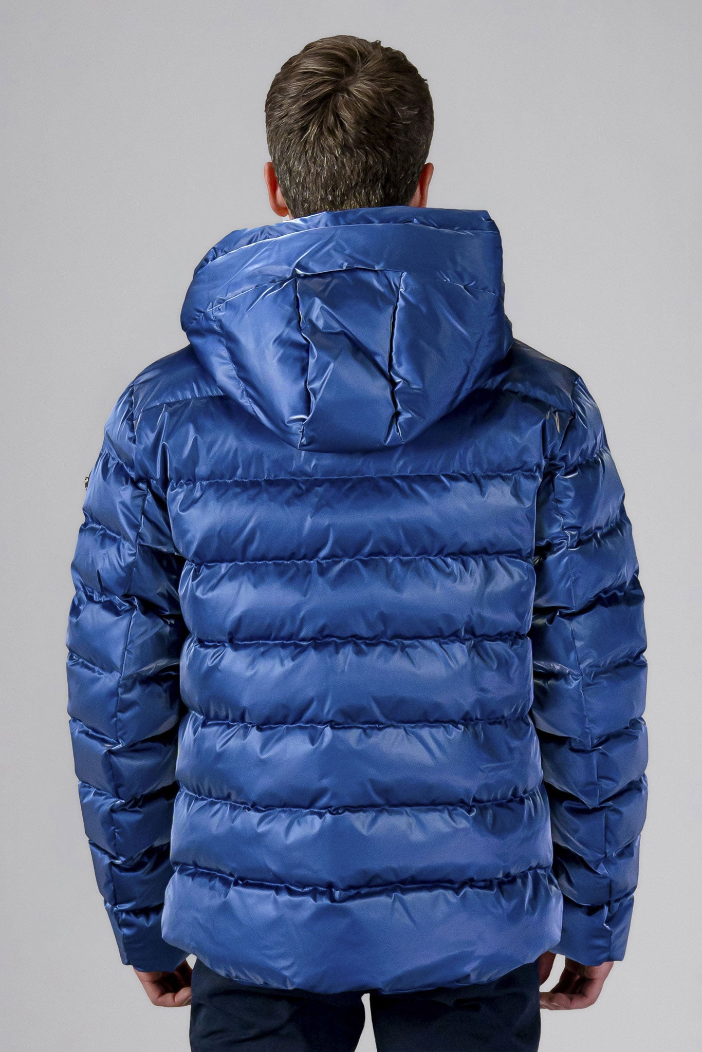 High-end Canadian designer winter coat for men in "Flash Blue" colour. Woodpecker cruelty-free winter coat designed in Canada. Men's medium weight medium length premium designer jacket for winter. Superior quality warm winter coat for men. Moose Knuckles, Canada Goose, Mackage, Montcler, Will Poho, Willbird, Nic Bayley. Shiny parka. Stylish winter jacket. Designer winter coat.