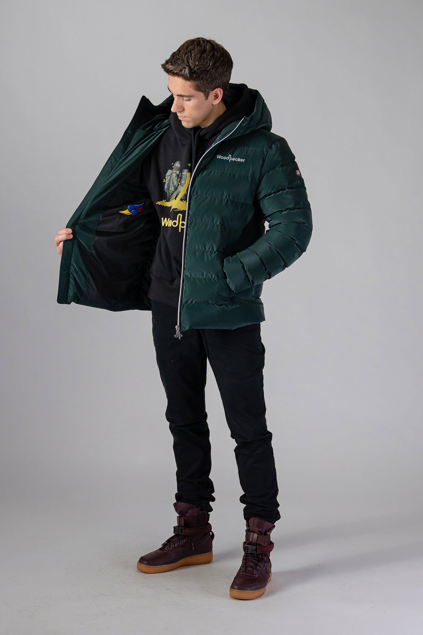 Woodpecker Men's Sparrow Winter coat. High-end Canadian designer winter coat for men in "Green Diamond" colour. Woodpecker cruelty-free winter coat designed in Canada. Men's medium weight medium length premium designer jacket for winter. Superior quality warm winter coat for men. Moose Knuckles, Canada Goose, Mackage, Montcler, Will Poho, Willbird, Nic Bayley. Shiny parka. Stylish winter jacket. Designer winter coat.