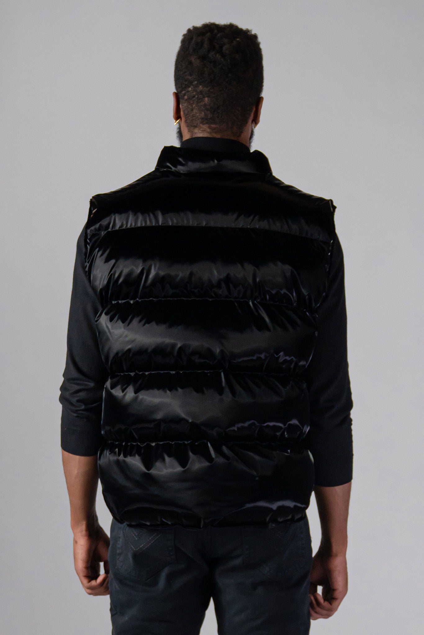 Woodpecker Unisex Winter Vest. High-end Canadian designer winter vest in "All Wet Black" colour. Woodpecker cruelty-free vest designed in Canada. Heavy weight short length premium designer vest for winter. Superior quality warm winter vest. Moose Knuckles, Canada Goose, Mackage, Montcler, Will Poho, Willbird, Nic Bayley. Extra warm. Shiny vest. Stylish winter vest. Designer winter vest.