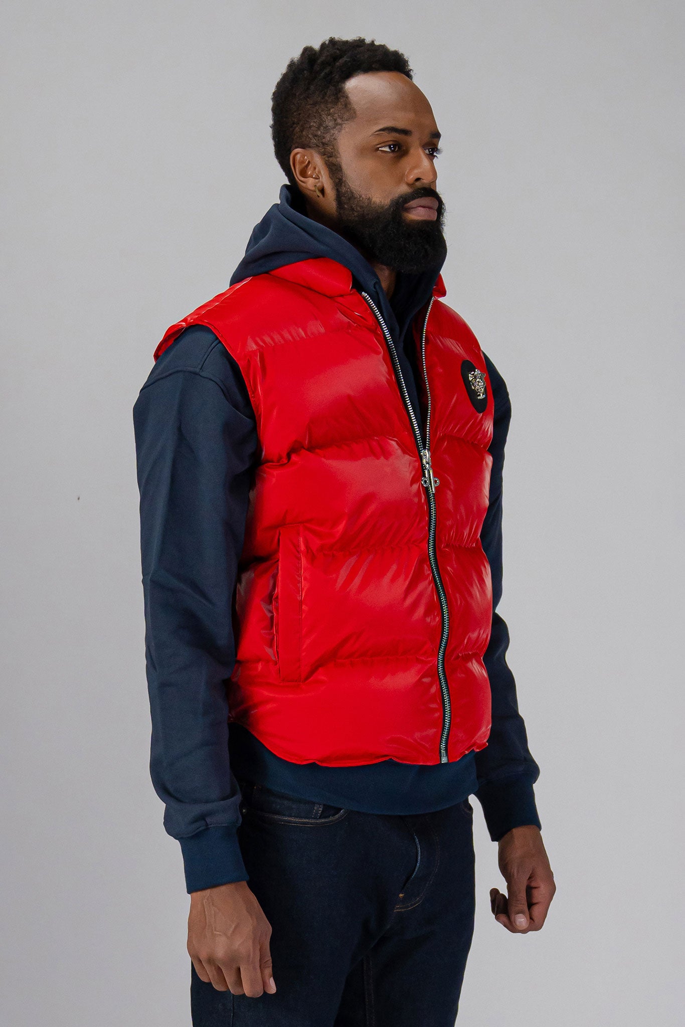 Woodpecker Unisex Winter Vest. High-end Canadian designer winter vest in "Fashion Santa" red colour. Woodpecker cruelty-free vest designed in Canada. Heavy weight short length premium designer vest for winter. Superior quality warm winter vest. Moose Knuckles, Canada Goose, Mackage, Montcler, Will Poho, Willbird, Nic Bayley. Extra warm. Shiny vest. Stylish winter vest. Designer winter vest.