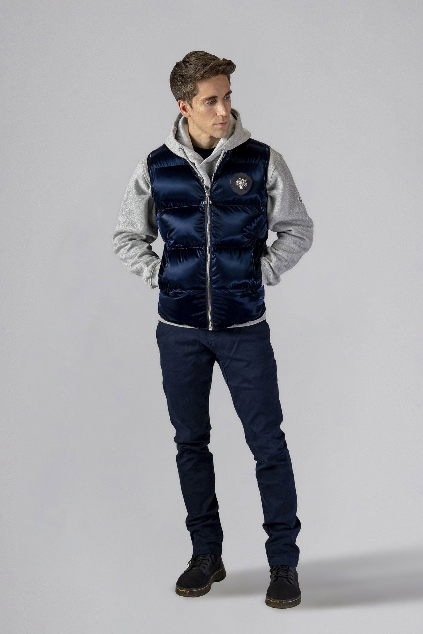 Woodpecker Unisex Winter Vest. High-end Canadian designer winter vest in "All Wet Navy" colour. Woodpecker cruelty-free vest designed in Canada. Heavy weight short length premium designer vest for winter. Superior quality warm winter vest. Moose Knuckles, Canada Goose, Mackage, Montcler, Will Poho, Willbird, Nic Bayley. Extra warm. Shiny vest. Stylish winter vest. Designer winter vest.