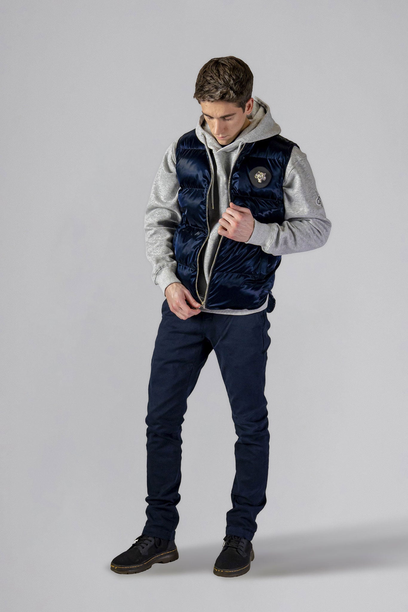 Woodpecker Unisex Winter Vest. High-end Canadian designer winter vest in "All Wet Navy" colour. Woodpecker cruelty-free vest designed in Canada. Heavy weight short length premium designer vest for winter. Superior quality warm winter vest. Moose Knuckles, Canada Goose, Mackage, Montcler, Will Poho, Willbird, Nic Bayley. Extra warm. Shiny vest. Stylish winter vest. Designer winter vest.