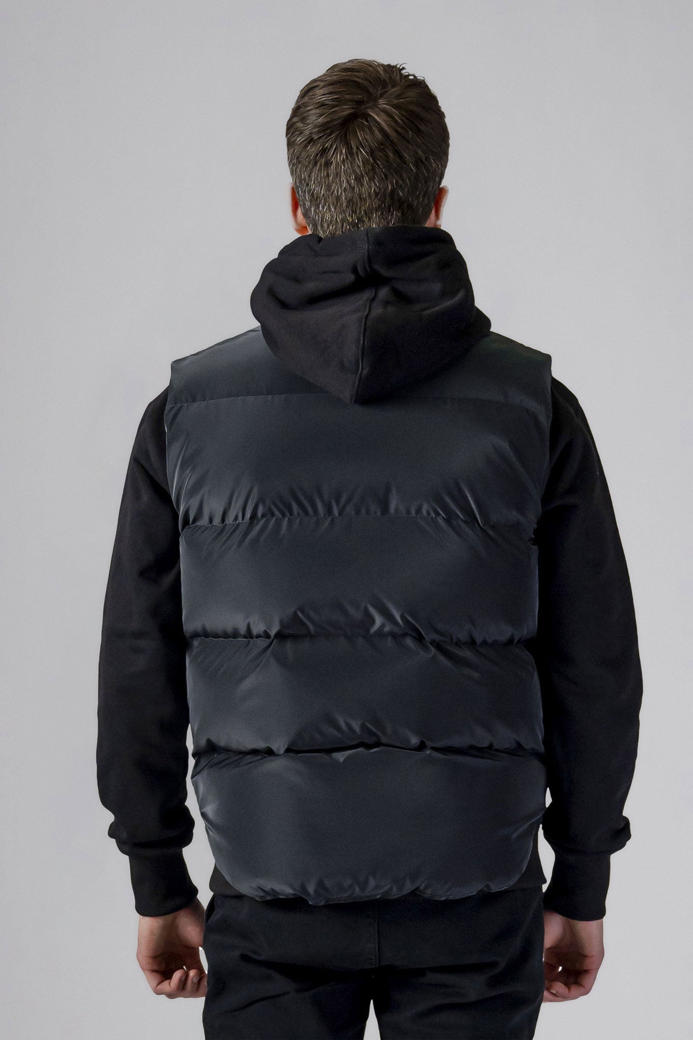 Woodpecker Unisex Winter Vest. High-end Canadian designer winter vest in "Black Diamond" colour. Woodpecker cruelty-free vest designed in Canada. Heavy weight short length premium designer vest for winter. Superior quality warm winter vest. Moose Knuckles, Canada Goose, Mackage, Montcler, Will Poho, Willbird, Nic Bayley. Extra warm. Shiny vest. Stylish winter vest. Designer winter vest.