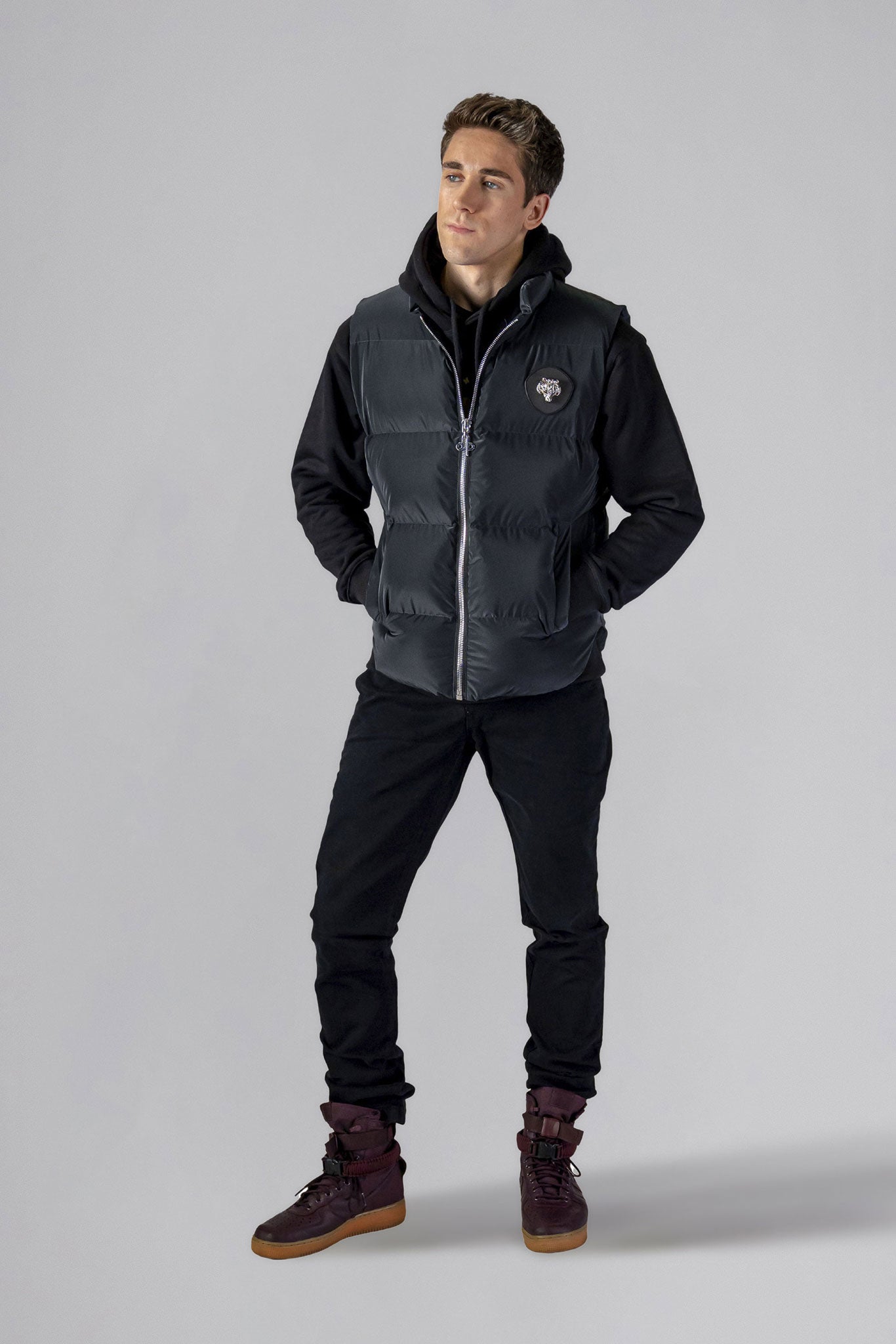 Woodpecker Unisex Winter Vest. High-end Canadian designer winter vest in "Black Diamond" colour. Woodpecker cruelty-free vest designed in Canada. Heavy weight short length premium designer vest for winter. Superior quality warm winter vest. Moose Knuckles, Canada Goose, Mackage, Montcler, Will Poho, Willbird, Nic Bayley. Extra warm. Shiny vest. Stylish winter vest. Designer winter vest.