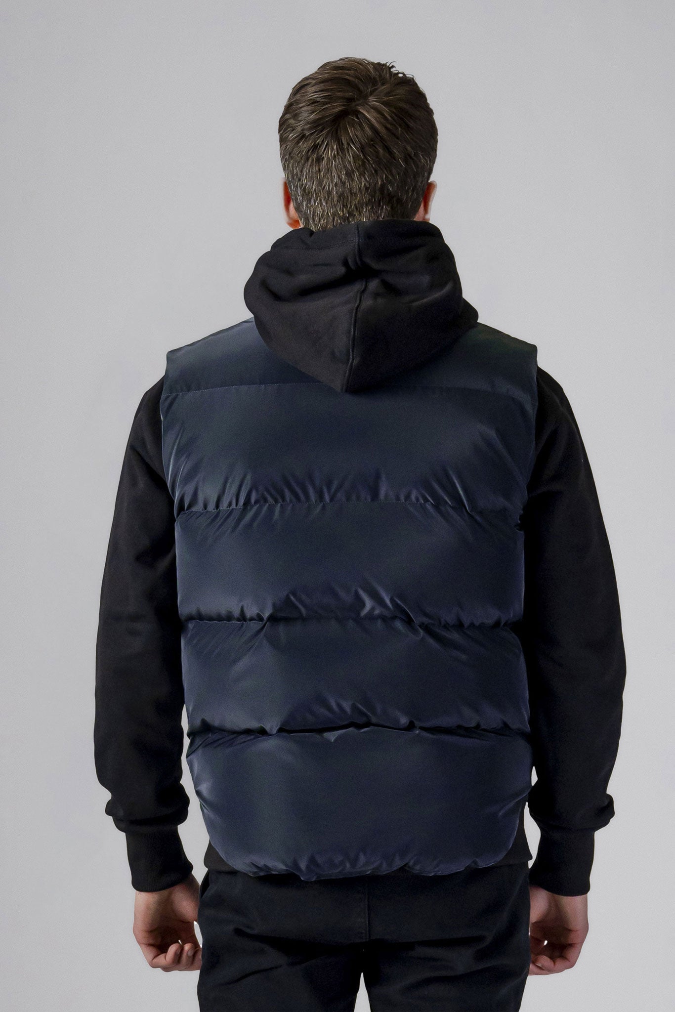 Woodpecker Unisex Winter Vest. High-end Canadian designer winter vest in "Blue Diamond" colour. Woodpecker cruelty-free vest designed in Canada. Heavy weight short length premium designer vest for winter. Superior quality warm winter vest. Moose Knuckles, Canada Goose, Mackage, Montcler, Will Poho, Willbird, Nic Bayley. Extra warm. Shiny vest. Stylish winter vest. Designer winter vest.