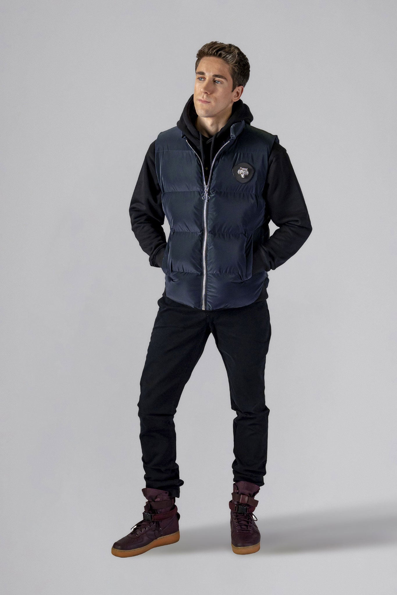 Woodpecker Unisex Winter Vest. High-end Canadian designer winter vest in "Blue Diamond" colour. Woodpecker cruelty-free vest designed in Canada. Heavy weight short length premium designer vest for winter. Superior quality warm winter vest. Moose Knuckles, Canada Goose, Mackage, Montcler, Will Poho, Willbird, Nic Bayley. Extra warm. Shiny vest. Stylish winter vest. Designer winter vest.