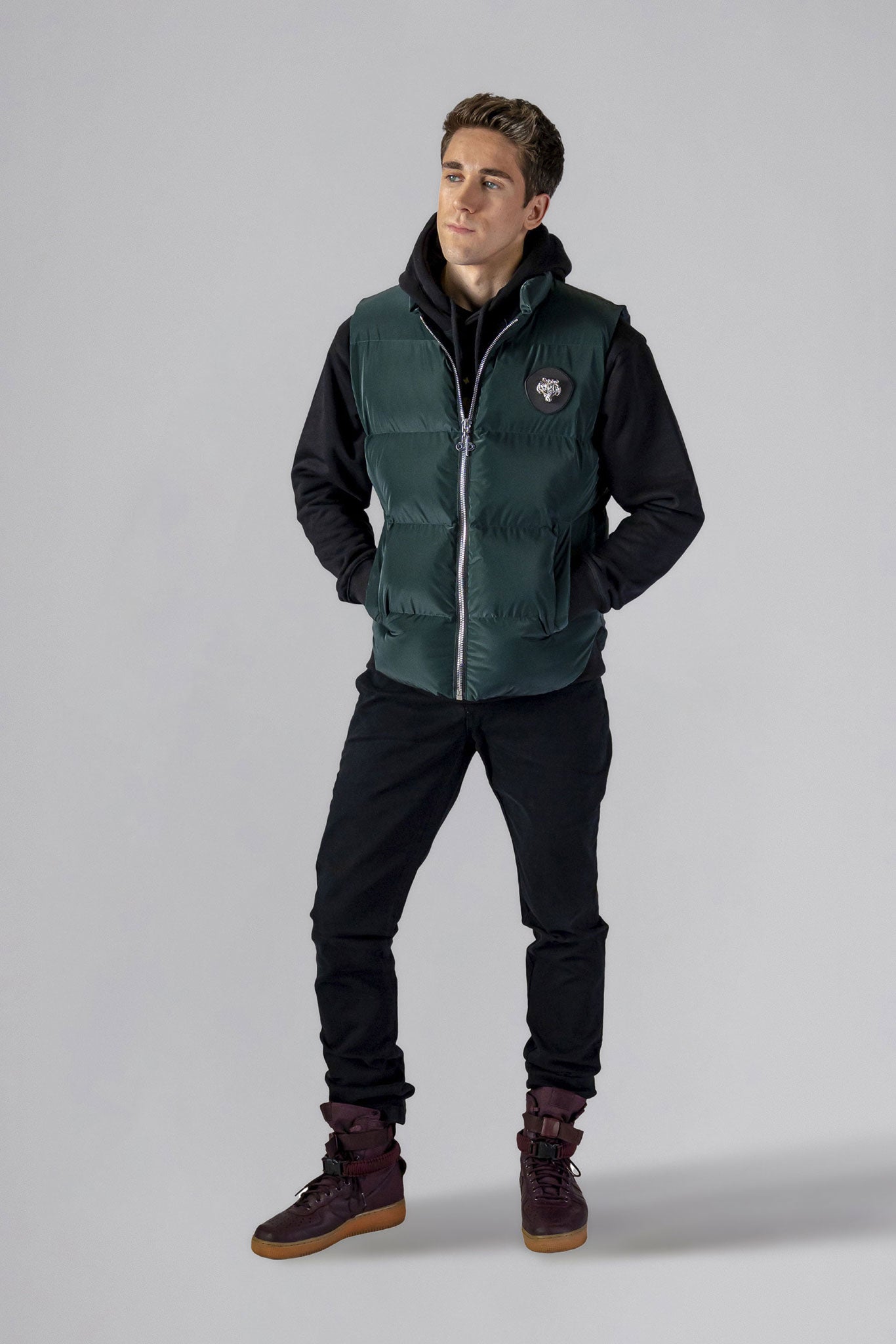 Woodpecker Unisex Winter Vest. High-end Canadian designer winter vest in "Green Diamond" colour. Woodpecker cruelty-free vest designed in Canada. Heavy weight short length premium designer vest for winter. Superior quality warm winter vest. Moose Knuckles, Canada Goose, Mackage, Montcler, Will Poho, Willbird, Nic Bayley. Extra warm. Shiny vest. Stylish winter vest. Designer winter vest.