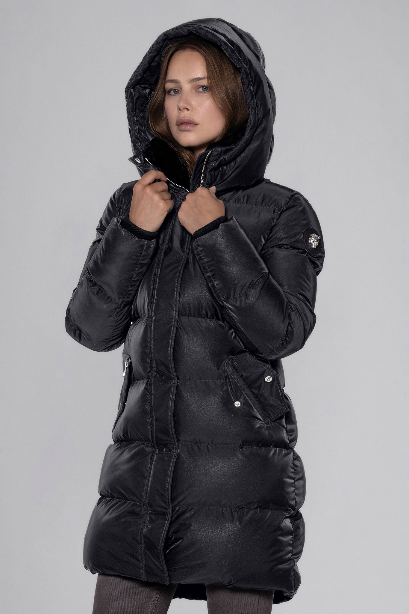 Woodpecker Women's Penguin Long Winter coat. High-end Canadian designer winter coat for women in "Black Diamond" colour. Woodpecker cruelty-free winter coat designed in Canada. Women's heavy weight long length premium designer jacket for winter. Superior quality warm winter coat for women. Moose Knuckles, Canada Goose, Mackage, Montcler, Will Poho, Willbird, Nic Bayley. Extra warm. Shiny parka. Stylish winter jacket. Designer winter coat.