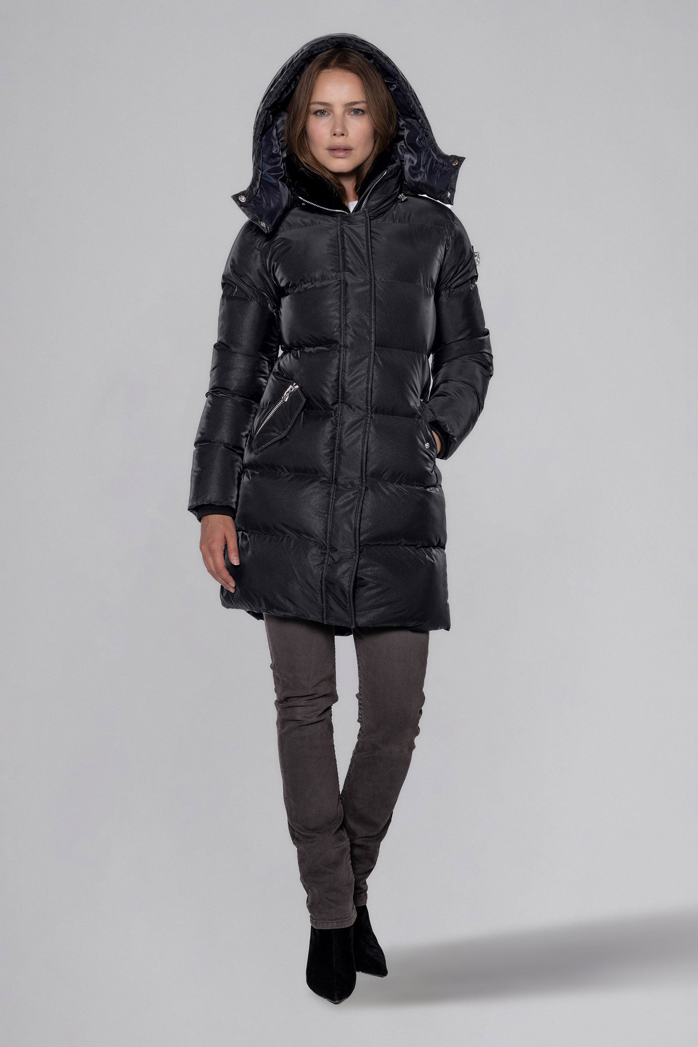 Woodpecker Women's Penguin Long Winter coat. High-end Canadian designer winter coat for women in "Black Diamond" colour. Woodpecker cruelty-free winter coat designed in Canada. Women's heavy weight long length premium designer jacket for winter. Superior quality warm winter coat for women. Moose Knuckles, Canada Goose, Mackage, Montcler, Will Poho, Willbird, Nic Bayley. Extra warm. Shiny parka. Stylish winter jacket. Designer winter coat.