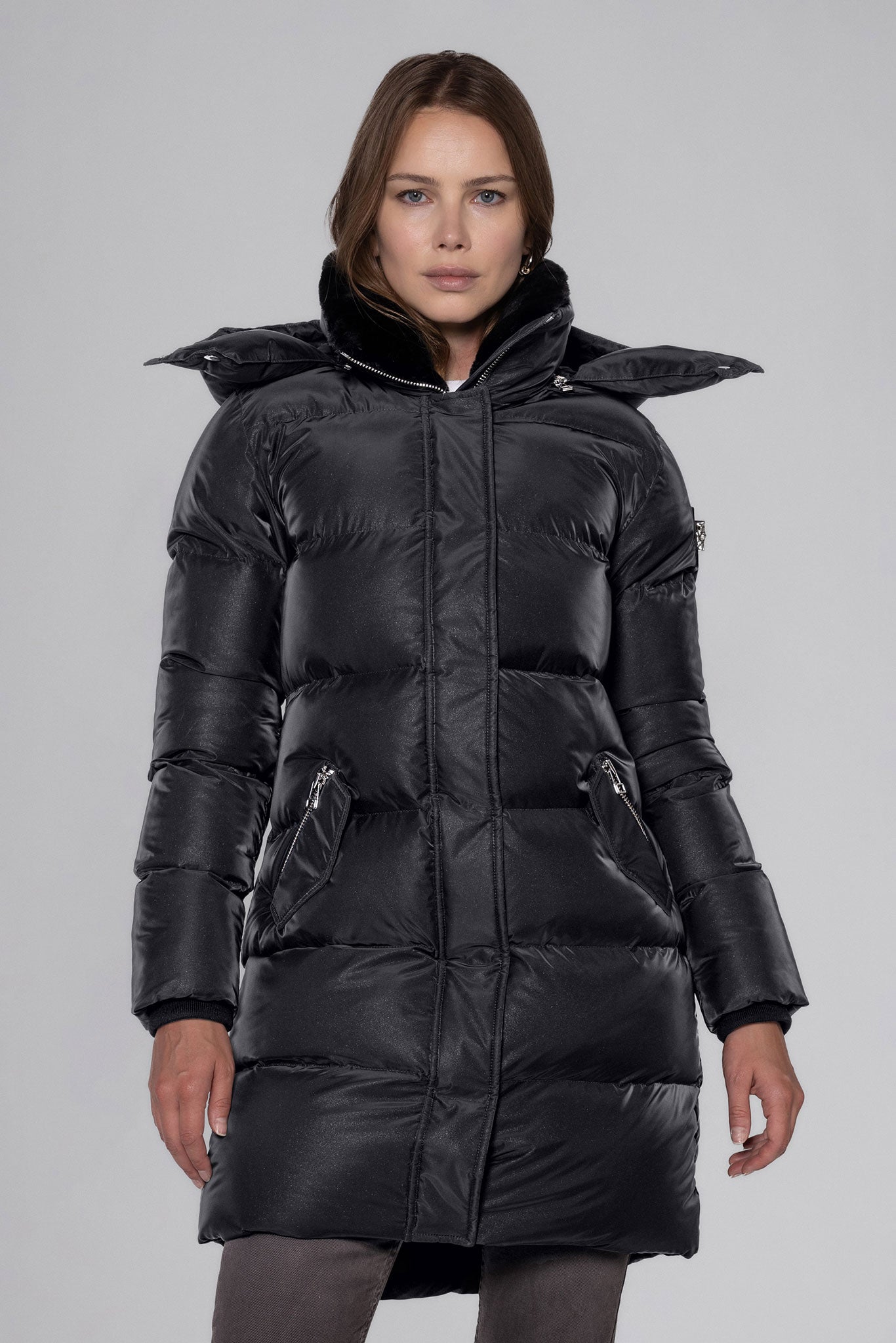 Woodpecker Women's Penguin Long Winter coat. High-end Canadian designer winter coat for women in "Black Diamond" colour. Woodpecker cruelty-free winter coat designed in Canada. Women's heavy weight long length premium designer jacket for winter. Superior quality warm winter coat for women. Moose Knuckles, Canada Goose, Mackage, Montcler, Will Poho, Willbird, Nic Bayley. Extra warm. Shiny parka. Stylish winter jacket. Designer winter coat.