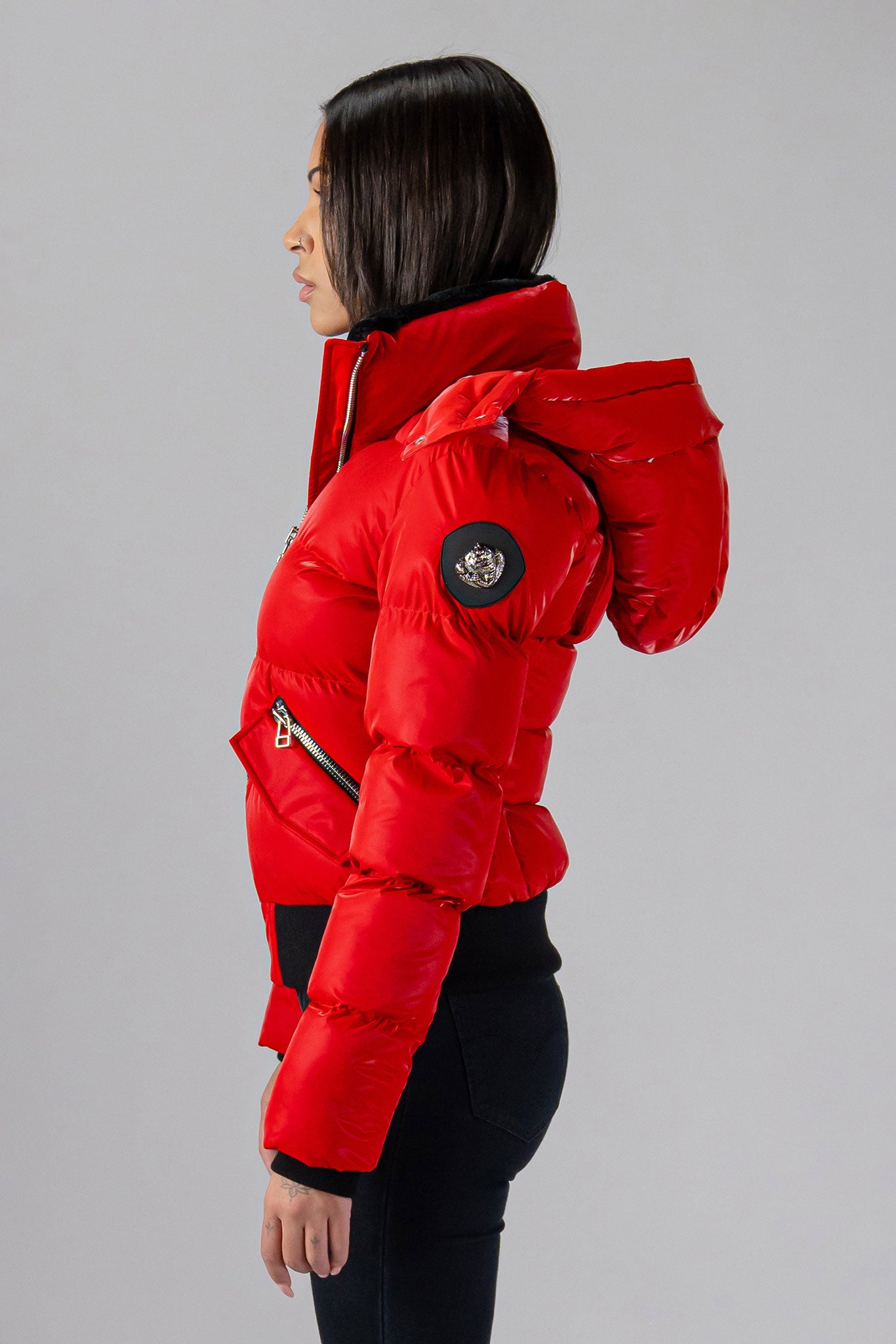 Woodpecker Women's Woody Bomber Winter coat. High-end Canadian designer winter coat for women in shiny “All Wet Red". Woodpecker cruelty-free winter coat designed in Canada. Women's heavy weight short length premium designer jacket for winter. Superior quality warm winter coat for women. Moose Knuckles, Canada Goose, Mackage, Montcler, Will Poho, Willbird, Nic Bayley. Shiny parka. Stylish winter jacket. Designer winter coat.