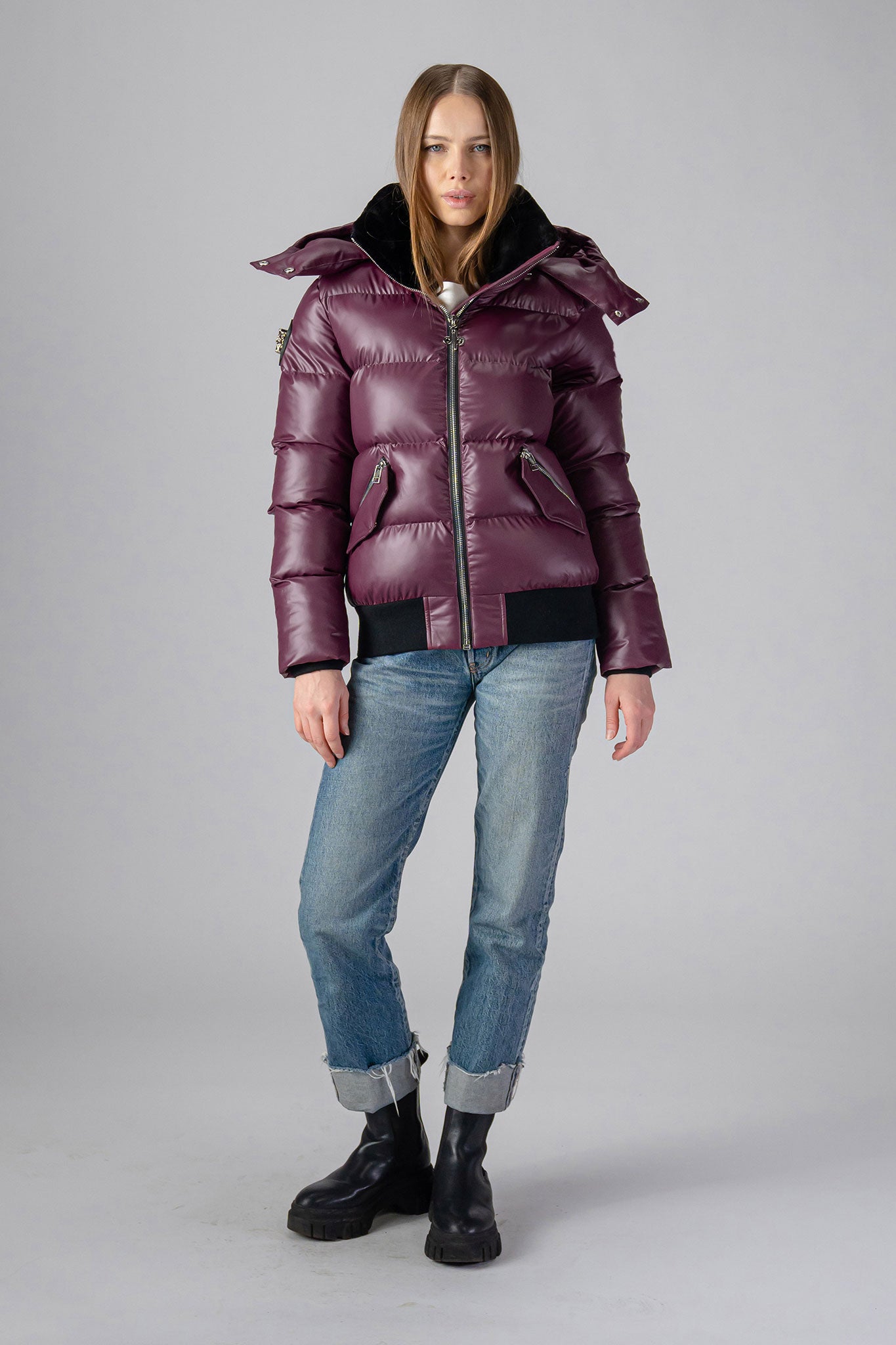 Woodpecker Women's Woody Bomber Winter coat. High-end Canadian designer winter coat for women in "Plum" colour. Woodpecker cruelty-free winter coat designed in Canada. Women's heavy weight short length premium designer jacket for winter. Superior quality warm winter coat for women. Moose Knuckles, Canada Goose, Mackage, Montcler, Will Poho, Willbird, Nic Bayley. Shiny parka. Stylish winter jacket. Designer winter coat.
