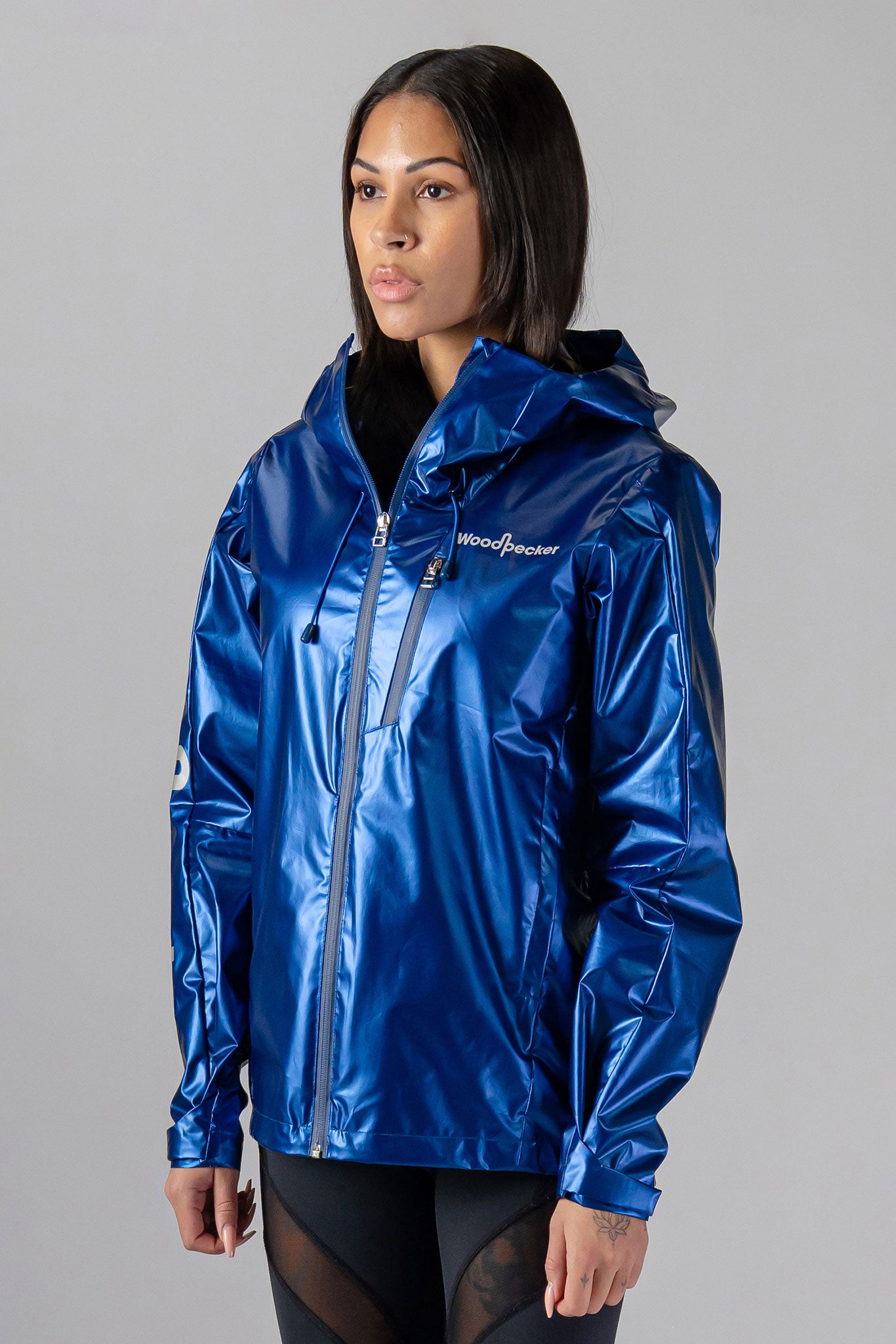 Woodpecker Women's Wind Shell coat. High-end Canadian designer activewear coat for women in "Flash Blue" colour. Woodpecker coat designed in Canada. Moose Knuckles, Canada Goose, Mackage, Montcler, Will Poho, Willbird, Nic Bayley.