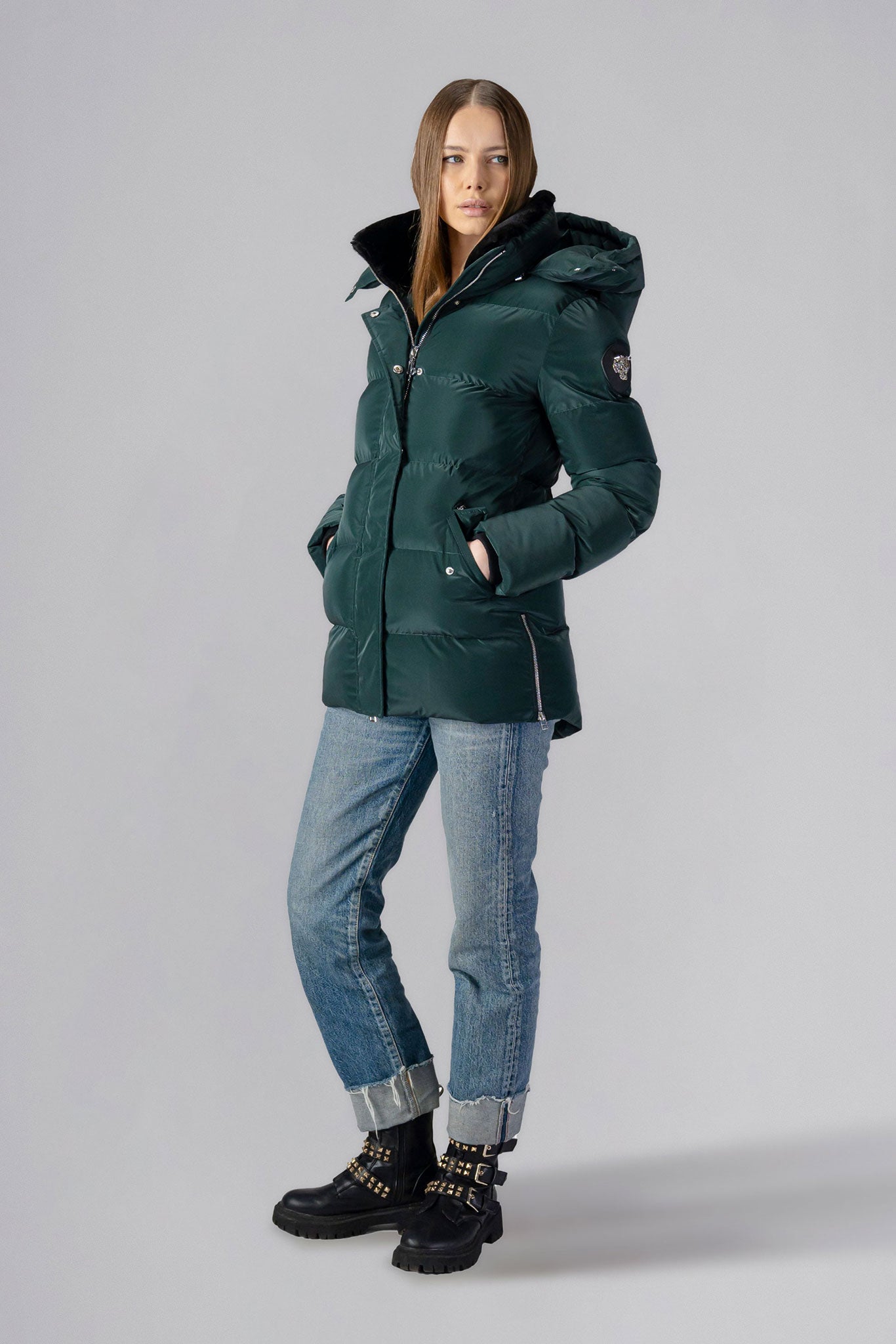 Woodpecker Women's Bumnester Winter coat. High-end Canadian designer winter coat for women in shiny "Green Diamond" colour. Woodpecker cruelty-free winter coat designed in Canada. Women's heavy weight medium length premium designer jacket for winter. Superior quality warm winter coat for women. Moose Knuckles, Canada Goose, Mackage, Montcler, Will Poho, Willbird, Nic Bayley. Extra warm. Shiny parka. Stylish winter jacket. Designer winter coat.