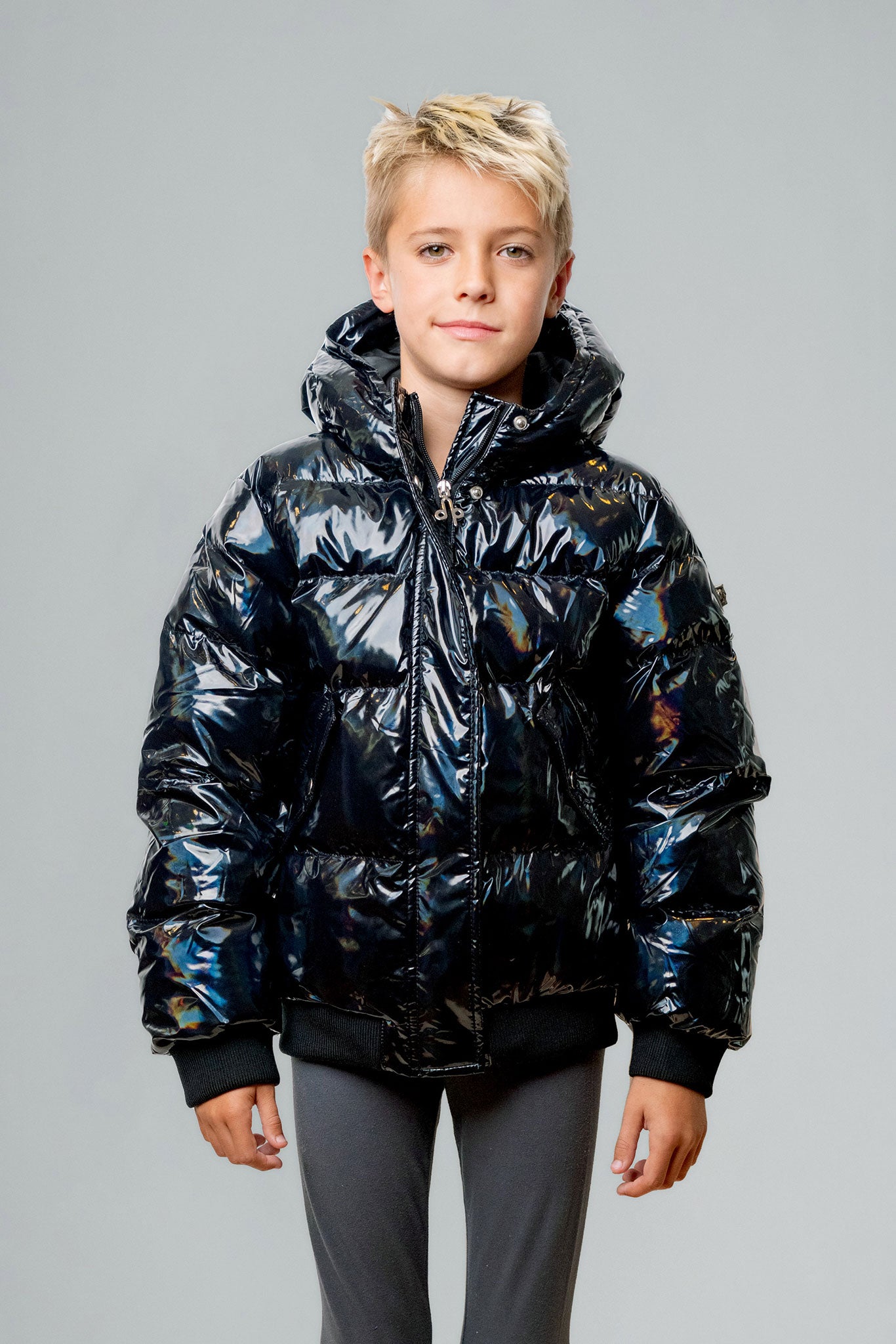 Woodpecker Kids' Chickadee Winter coat. High-end Canadian designer winter coat for Kids in "Oily Black" colour. Woodpecker cruelty-free winter coat designed in Canada. Kids' heavy weight short length premium designer jacket for winter. Superior quality warm winter coat for kids. Moose Knuckles, Canada Goose, Mackage, Montcler, Will Poho, Willbird, Nic Bayley. Extra Warm. Shiny parka. Stylish winter jacket. Designer winter coat.