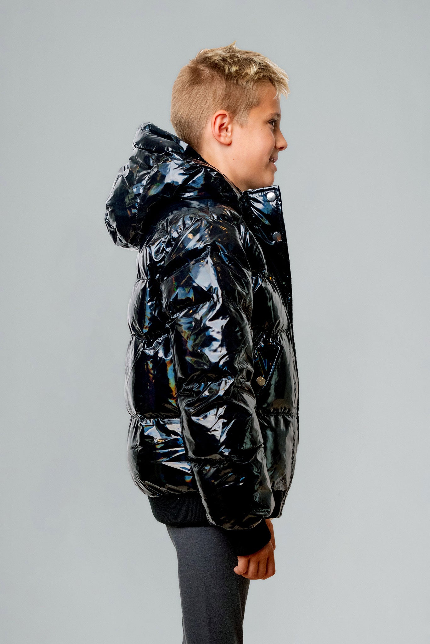 Woodpecker Kids' Chickadee Winter coat. High-end Canadian designer winter coat for Kids in "Oily Black" colour. Woodpecker cruelty-free winter coat designed in Canada. Kids' heavy weight short length premium designer jacket for winter. Superior quality warm winter coat for kids. Moose Knuckles, Canada Goose, Mackage, Montcler, Will Poho, Willbird, Nic Bayley. Extra Warm. Shiny parka. Stylish winter jacket. Designer winter coat.