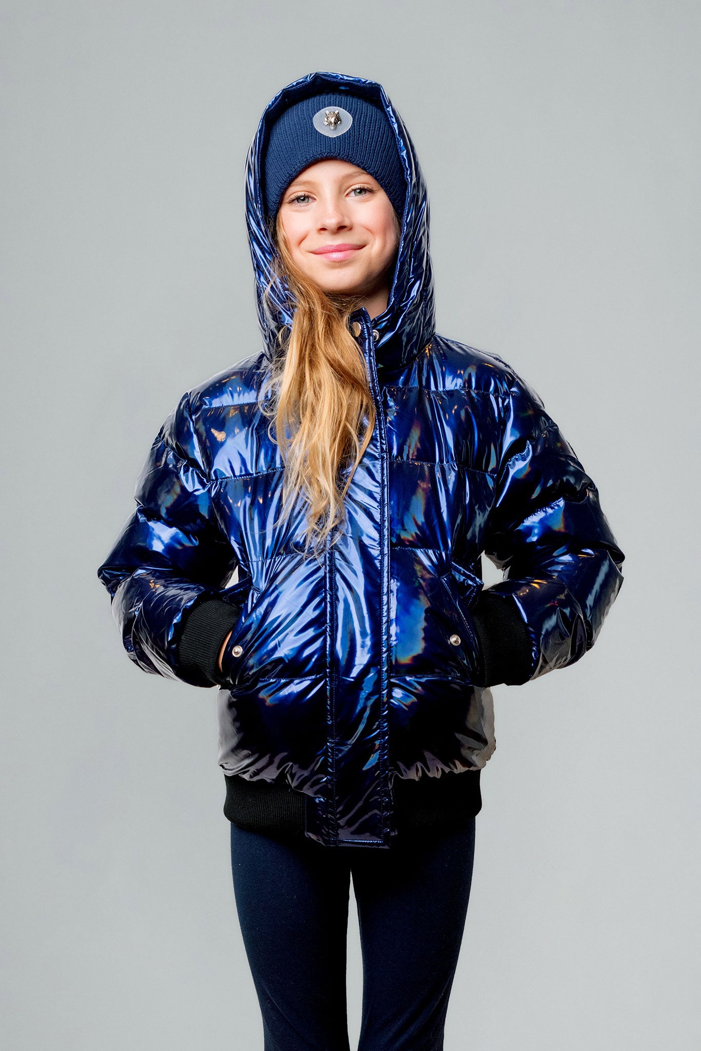 Woodpecker Kids' Chickadee Winter coat. High-end Canadian designer winter coat for Kids in "Oily Blue" colour. Woodpecker cruelty-free winter coat designed in Canada. Kids' heavy weight short length premium designer jacket for winter. Superior quality warm winter coat for kids. Moose Knuckles, Canada Goose, Mackage, Montcler, Will Poho, Willbird, Nic Bayley. Extra warm. Shiny parka. Stylish winter jacket. Designer winter coat.